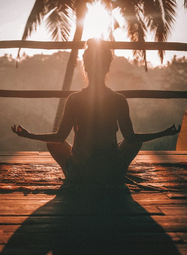 woman doing yoga meditation on brown parquet flooring